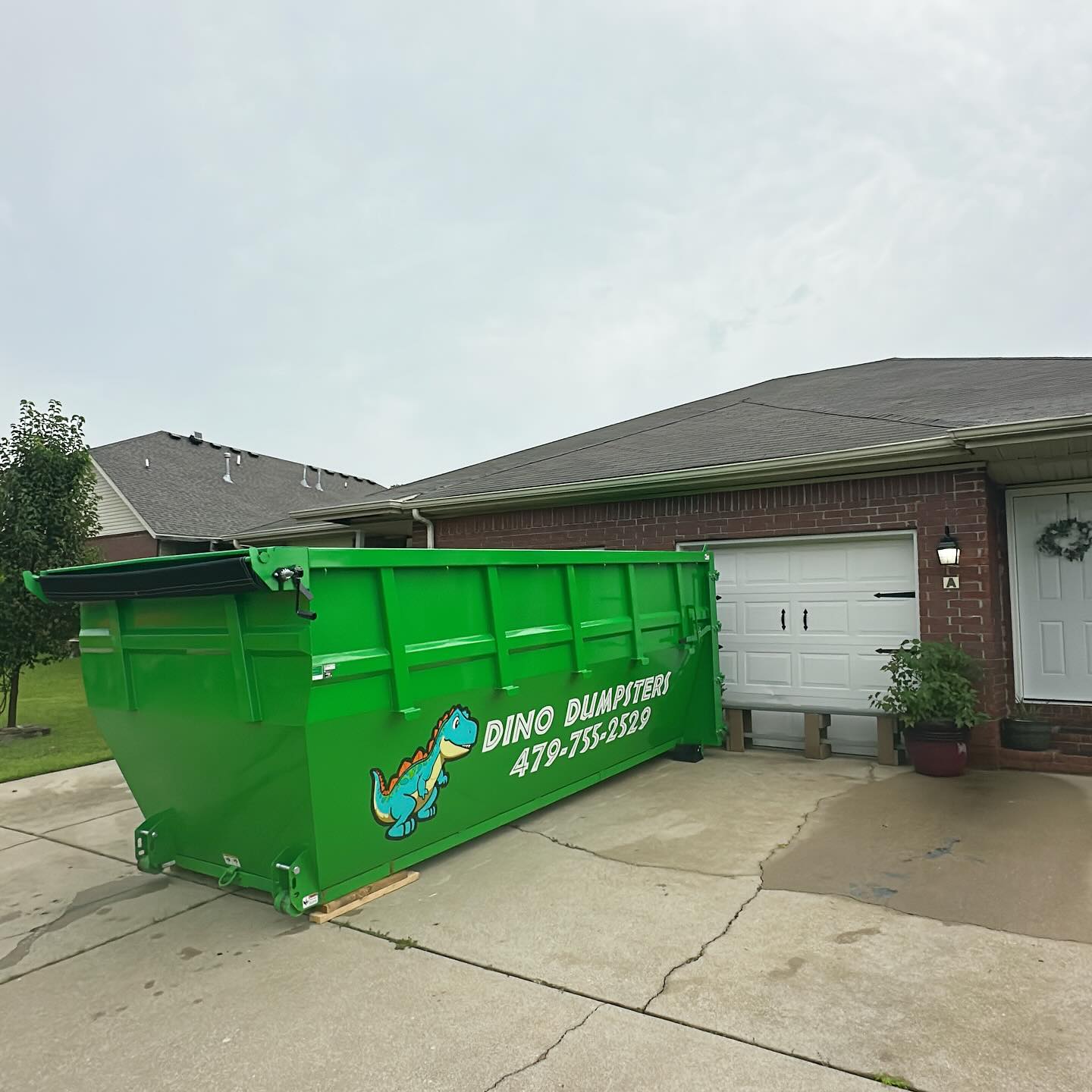 Dino Dumpsters dumpster on residential driveway